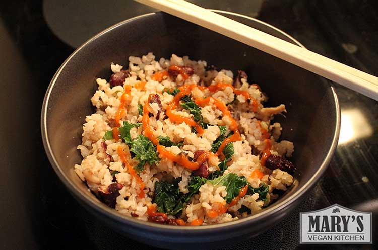 Shitake Mushroom, Beans and Rice with a sprinkling of kale chiffonade and Sriracha hot sauce.