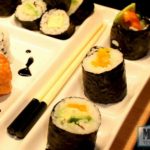 vegan sushi roll with avocado, sweet orange pepper and scallions