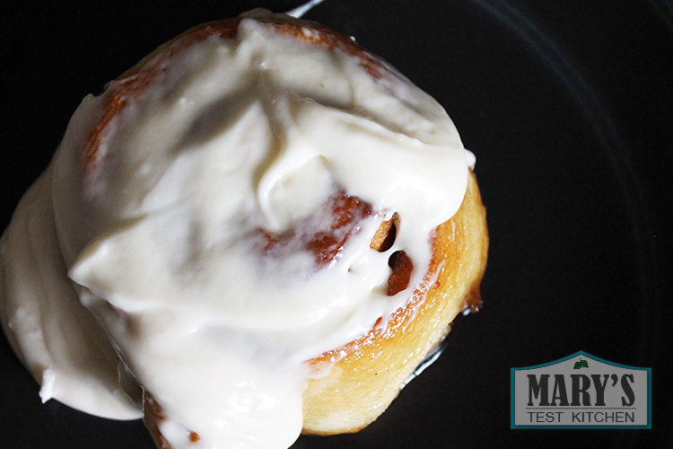 vegan cinnamon roll with icing from top view