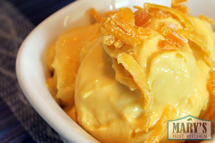 close up of mango ice cream topped with chopped dried mango