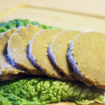 sliced seitan on lettuce