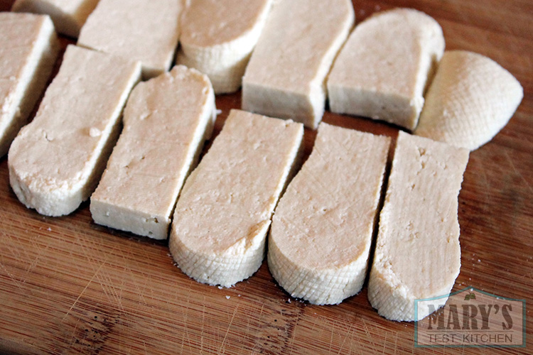 homemade tofu slices on bamboo board