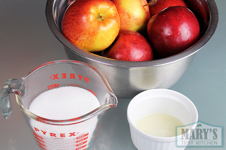 Bowl of apples, sugar and lemon juice.