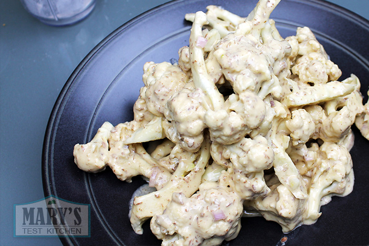 Battered, uncooked cauliflower. In a few minutes, they will turn from pasty grossness to golden, crisp deliciousness.