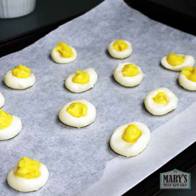 vegan creme egg fillings on parchment lined tray