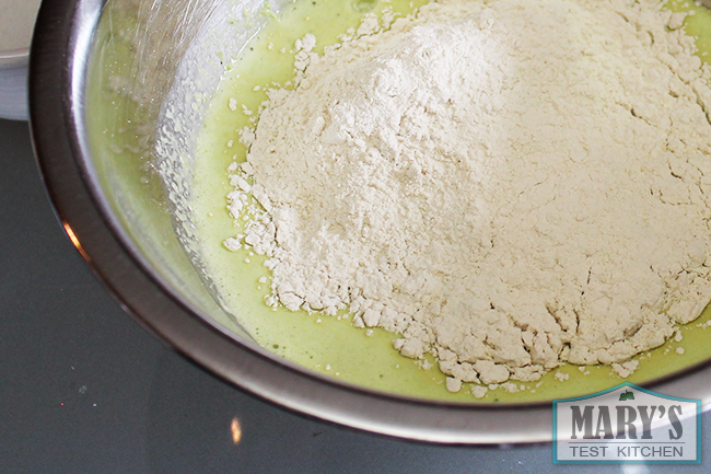 gluten flour in bowl of yellow liquid