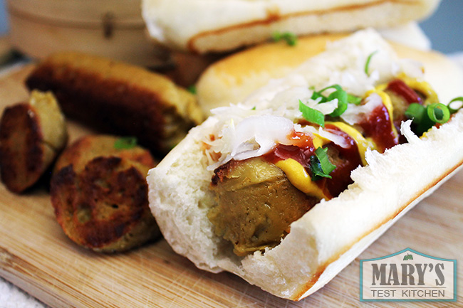vegan hot dog with ketchup, mustard, and sauerkraut
