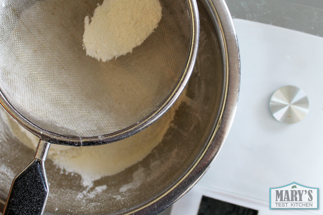 making-vegan-donuts-sifting-flour