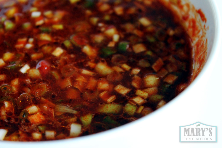 chopped green onion floating in gochugaru tofu marinade