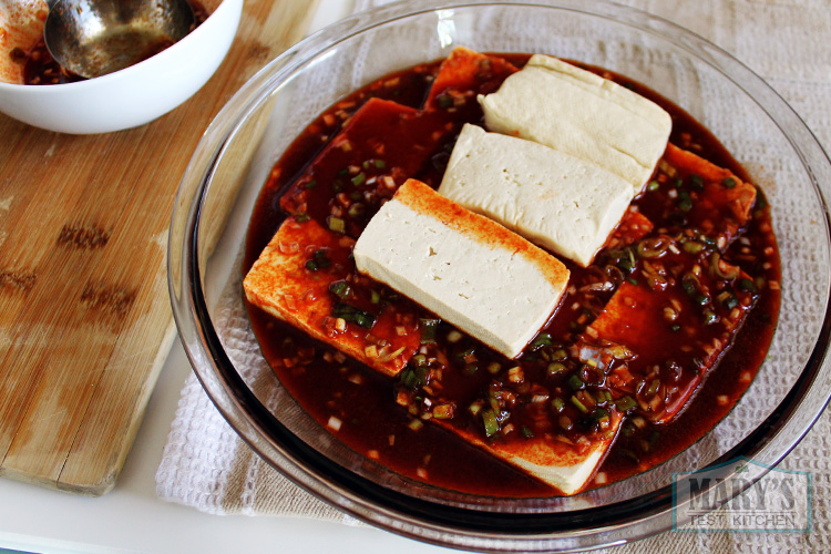 Tofu slices in sweet and spicy gochugaru marinade.