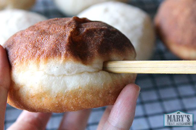 poking fried doughnut with chopstick