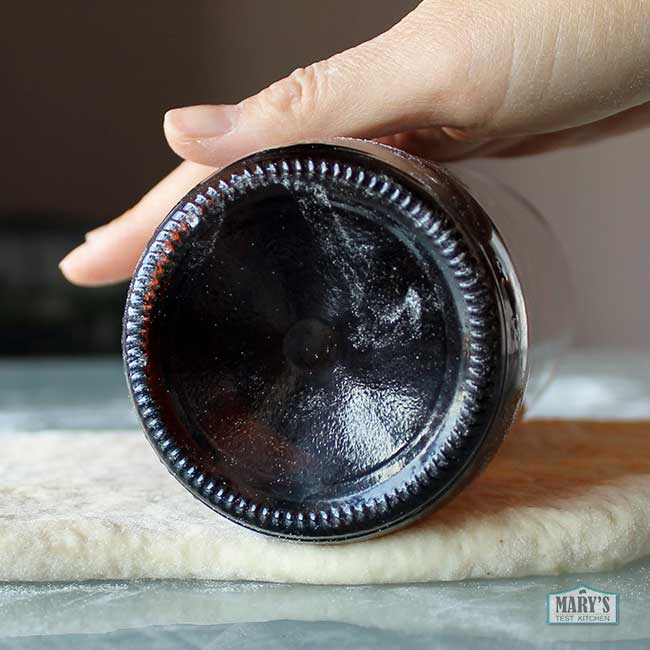 beer bottle rolling pin on dough