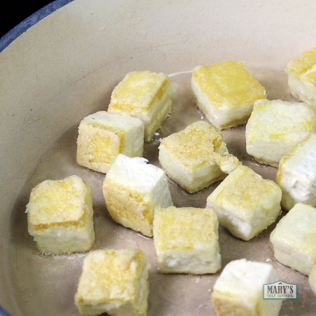 cornstarch-coated tofu getting crispy