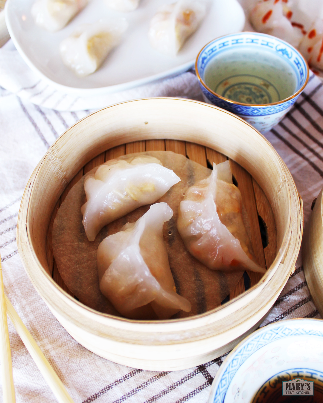 bamboo steamer with vegan crystal dumplings inside