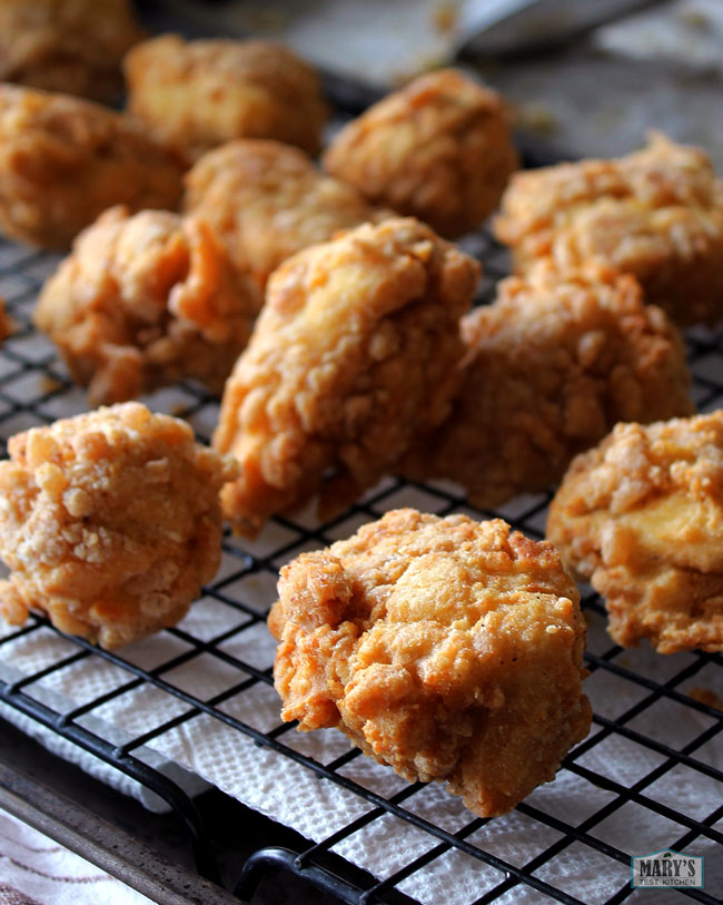 rack topped with several pieces of vegan fried chicken