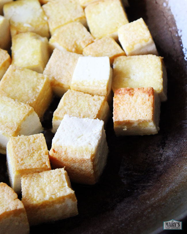 crispy chunks of tofu in the wok