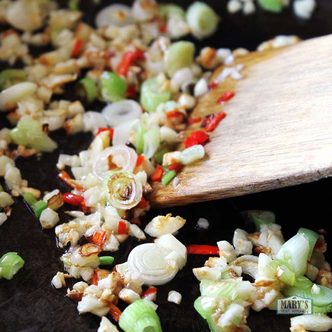 stir frying green onions, garlic and chilies