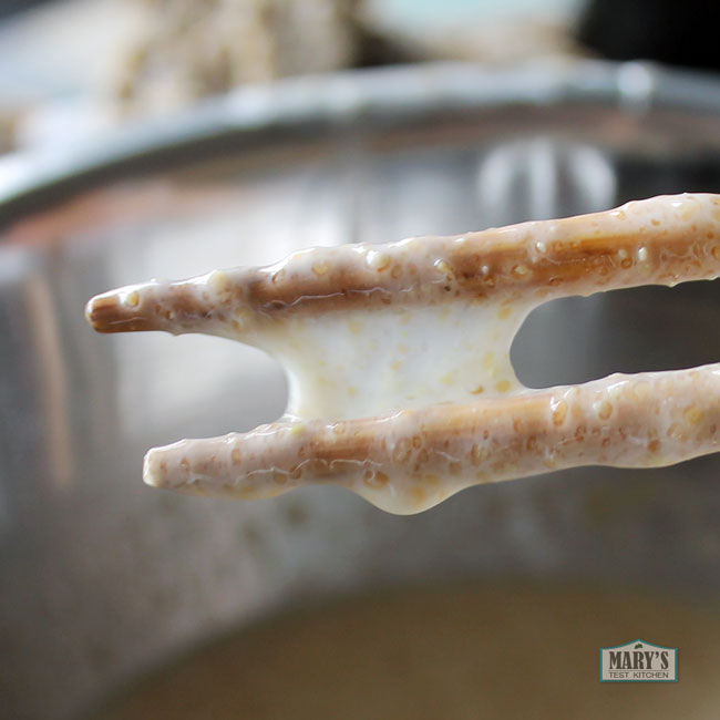 Gooey batter between chopsticks