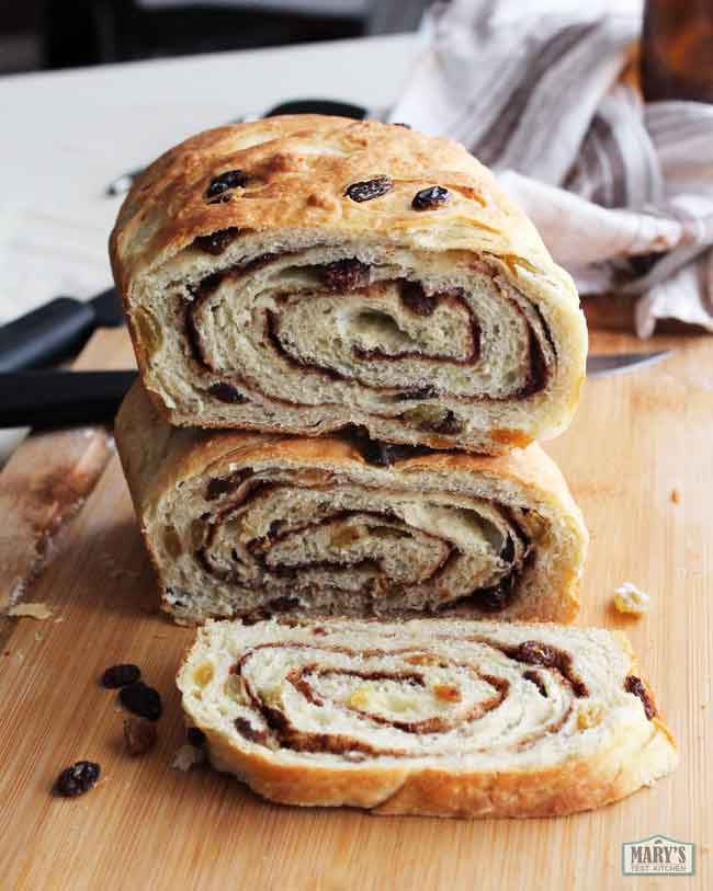 two halves of a vegan raisin bread loaf stacked