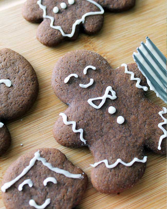 Close up vegan gingerbread man cookie with white icing