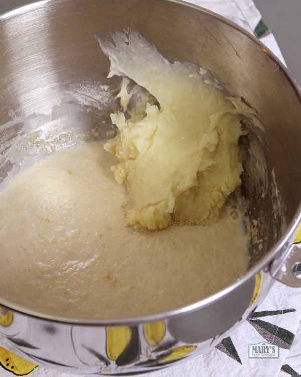 foamy yeast mixture and hot water flour paste in mixing bowl