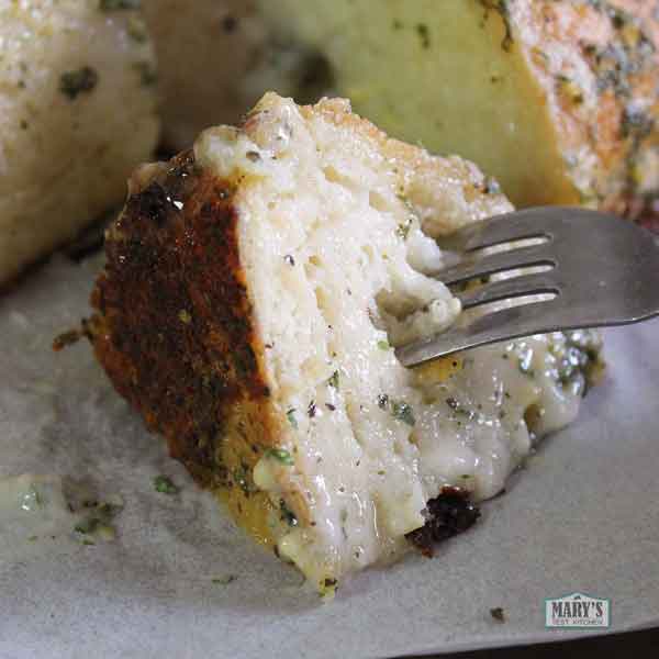 Vegan garlic cream cheese soaked wedge of bread