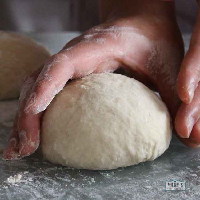 hands shaping a dough ball