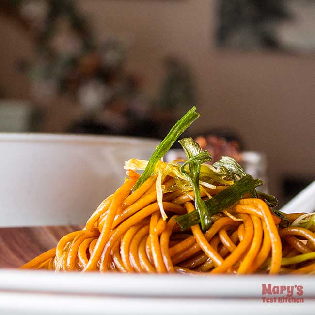 plate of green onion spaghetti with crispy onions on top