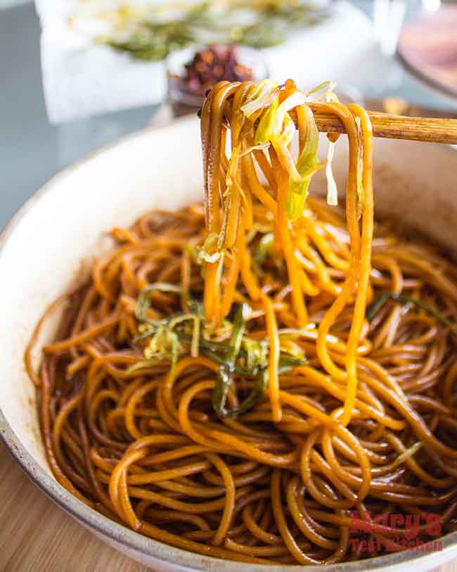 chopsticks full of green onion spaghetti