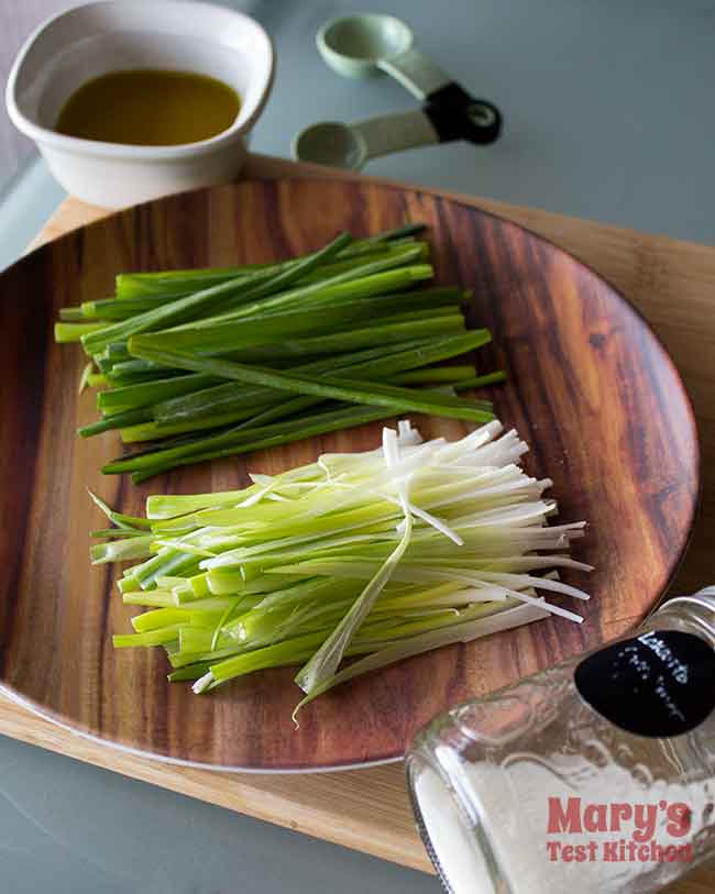 julienned green onions with oil and sweetener on table