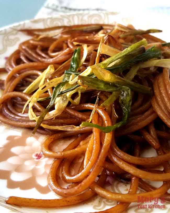 plate of green onion spaghetti noodles