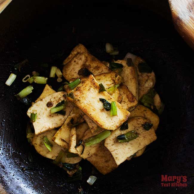 lemongrass pressed tofu piled high in wok