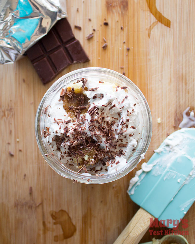 chocolate shavings on whipped coconut cream of a vegan tiramisu mug cake