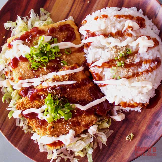 Plate of Tofu Katsu on bed of lettuce with side of rice