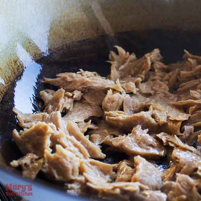 shredded vegan chicken in a oiled wok