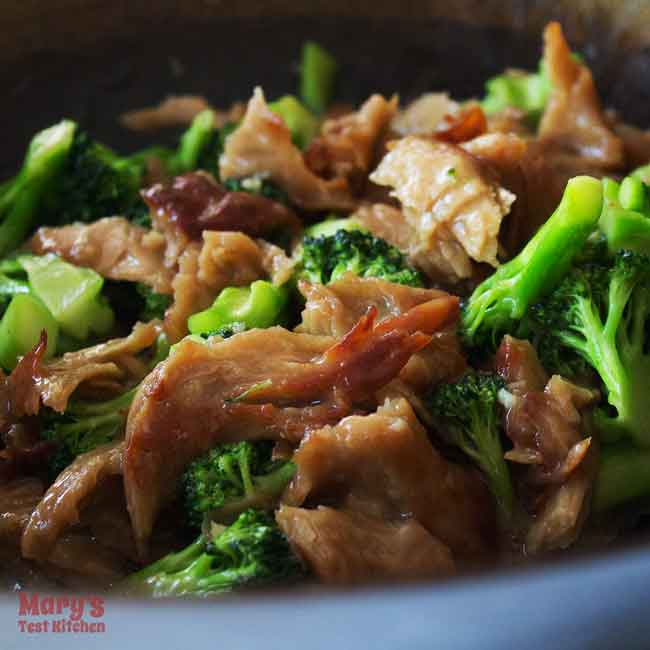 glossy stir fried vegan chicken and broccoli in wok