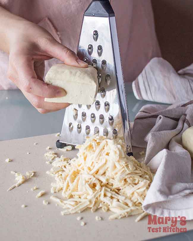 grating pressed tofu for vegan crab alternative