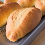 freshly baked Vietnamese baguettes on baking pan