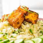 airfryer crispy tofu puffs on cauliflower rice with cucumber garnish