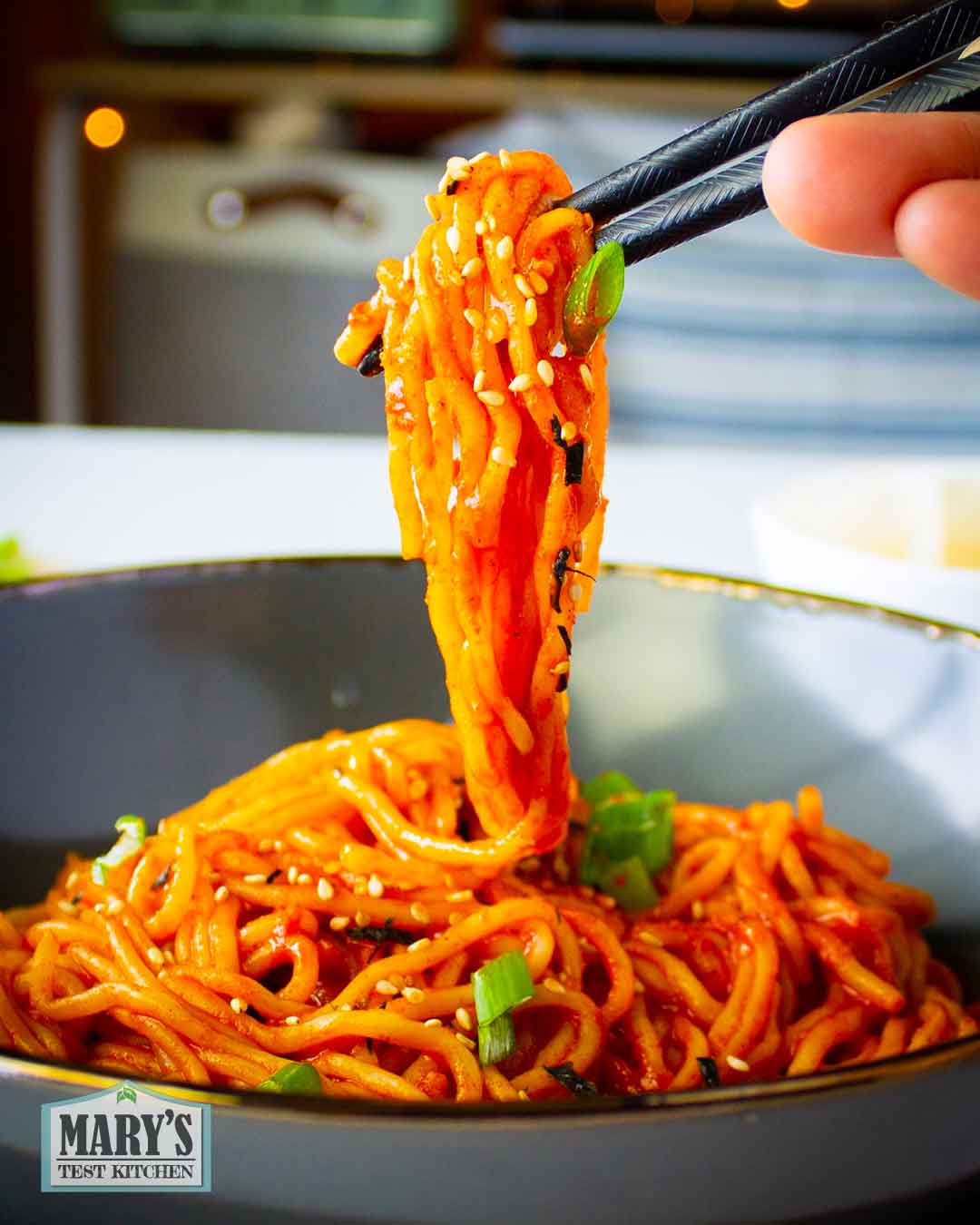 chopstick full of vegan korean hot chicken flavoured noodles