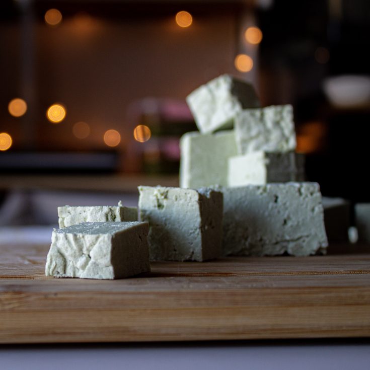 stacked cubes of pale green pumpkin seed tofu