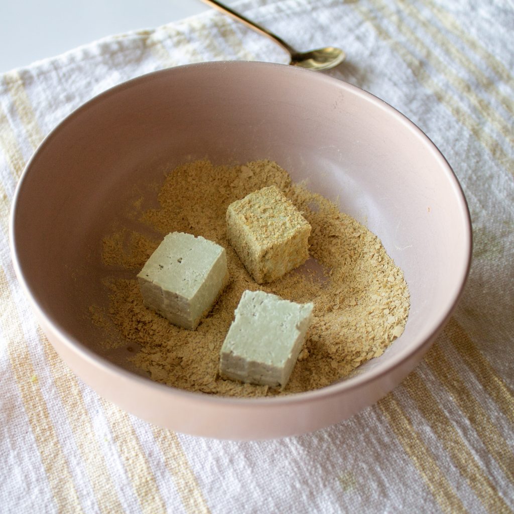 3 cubes of pumpkin seed tofu in seasoning