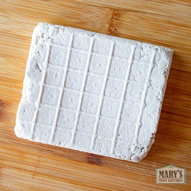 block of sunflower seed tofu on cutting board