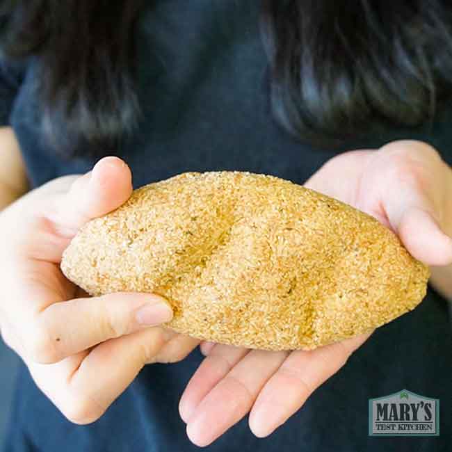 Mary holding a vegan keto gluten-free bun