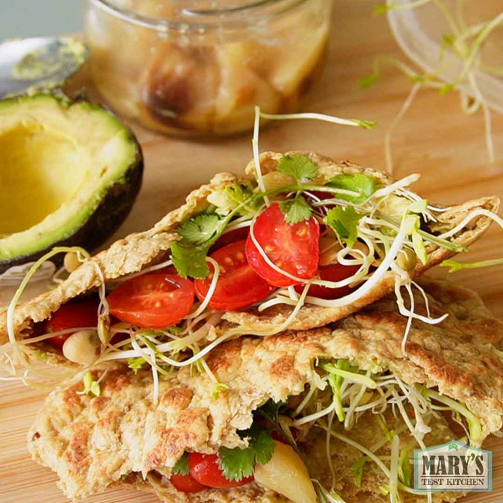 avocado tomato and sprouts in a vegan keto pita pocket sandwich