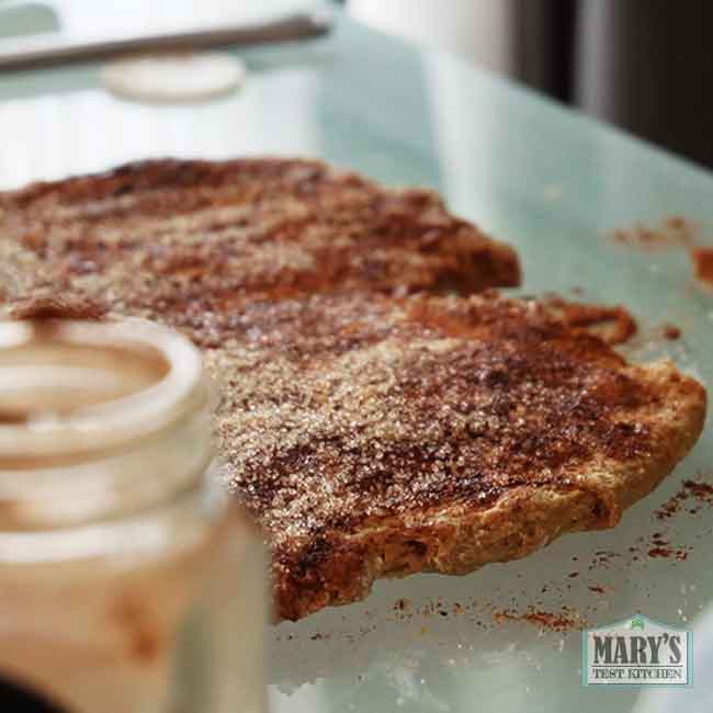 flattened vegan keto dough covered in cinnamon