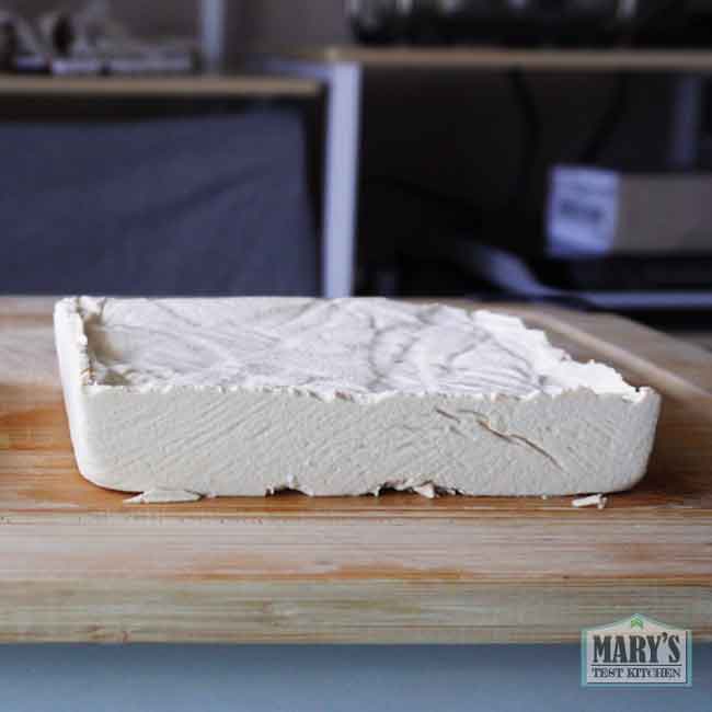 fresh yellow split pea tofu block on cutting board