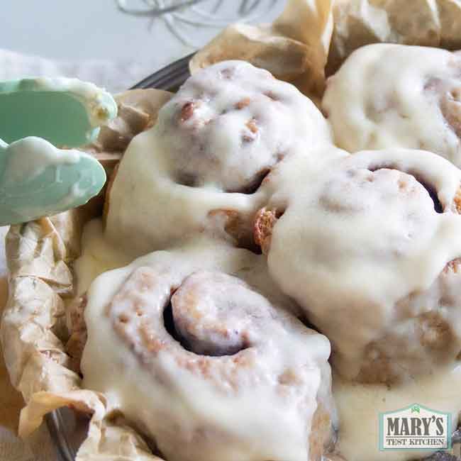 vegan keto cinnamon rolls with cream cheese frosting in pan