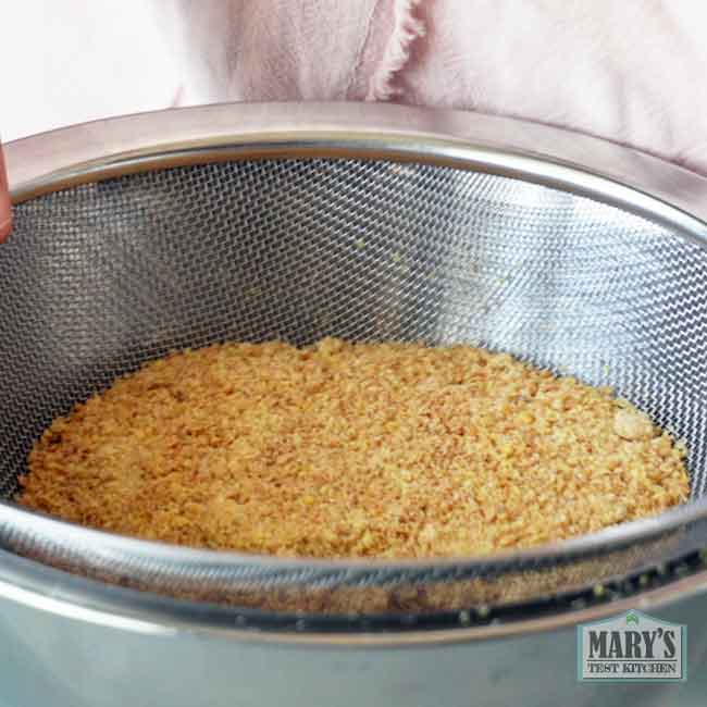 ground golden flax seed being sifted