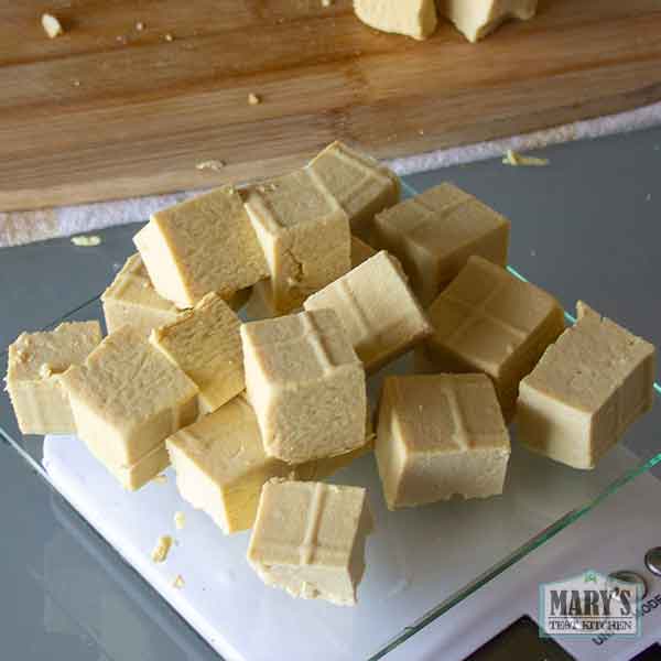 pile of pigeon pea tofu cubes on kitchen scale